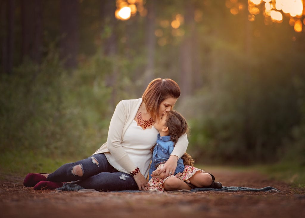Mother kissing daughter