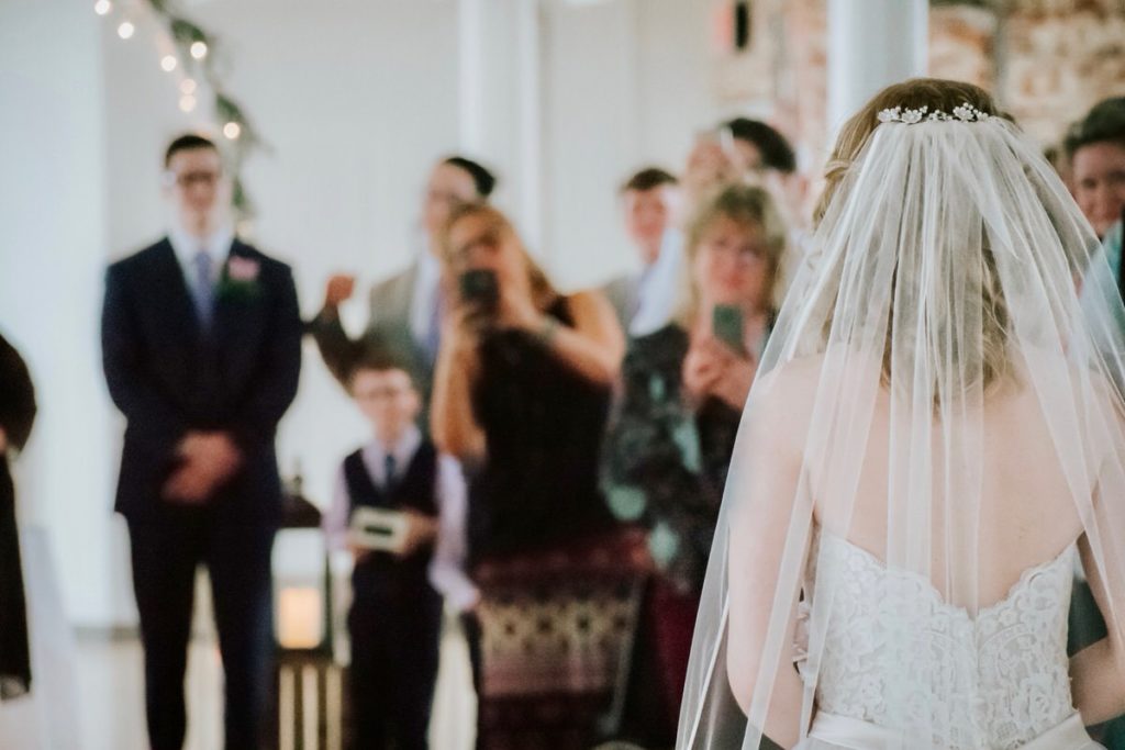 Bride and groom standing in front of people